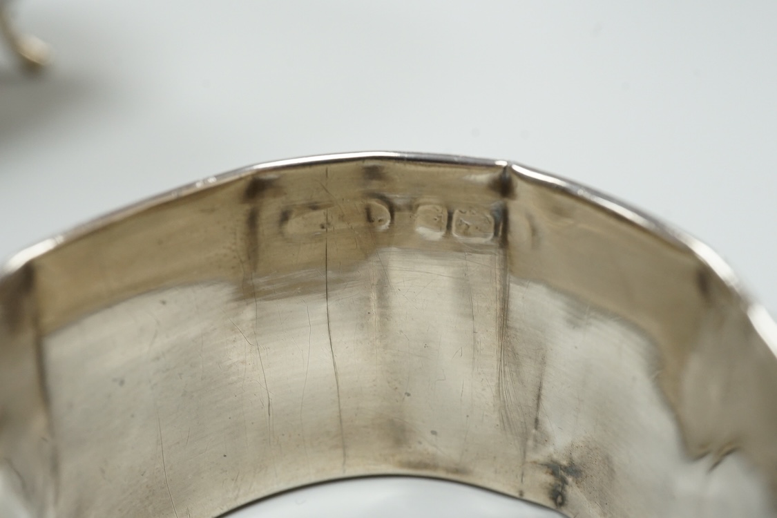 A late Victorian repousse silver navette shaped dish, by Charles Edwards, London, 1894, 25.7cm, with engraved monogram and date, together with a pair of mid 18th century silver sugar nips, an early 19th century silver vi